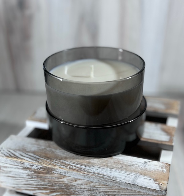 Soy and coconut wax blend candle in a round glass container with lid.